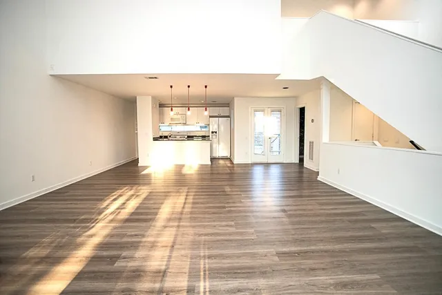 a kitchen with stainless steel appliances granite countertop a sink a stove a refrigerator a counter space and cabinets