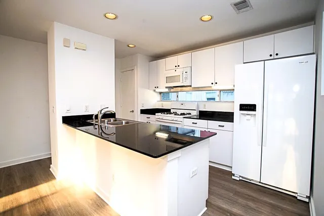 a kitchen with a sink stove and cabinets