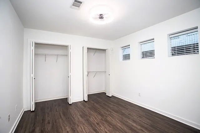 a view of a room with wooden floor