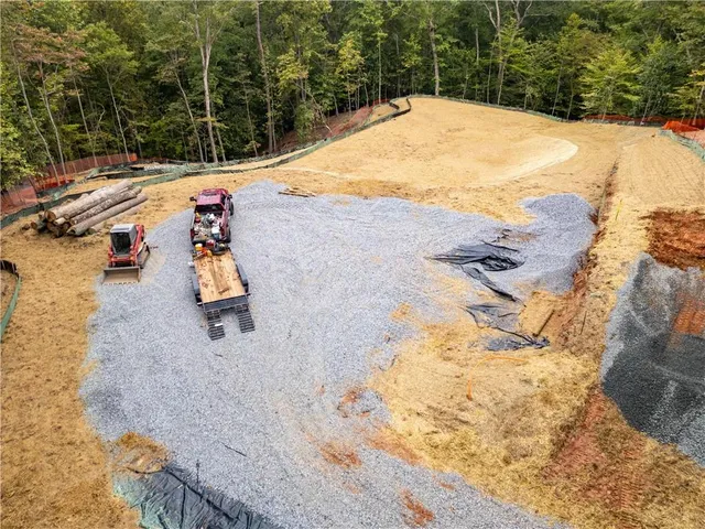 an aerial view of a houses with a yard