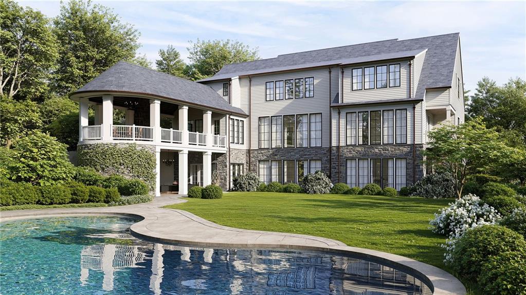 1945 West Paces Ferry Road Northwest Atlanta, GA 30327 - Photo 16 of 16 a front view of a house with a yard table and chairs