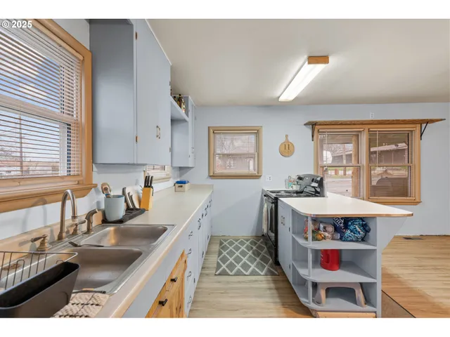 a kitchen with a sink stove and wooden cabinets