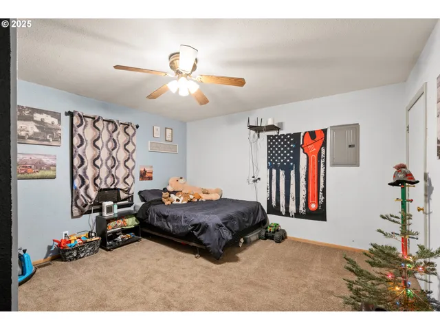 a bed room with a bed window and a flat screen tv