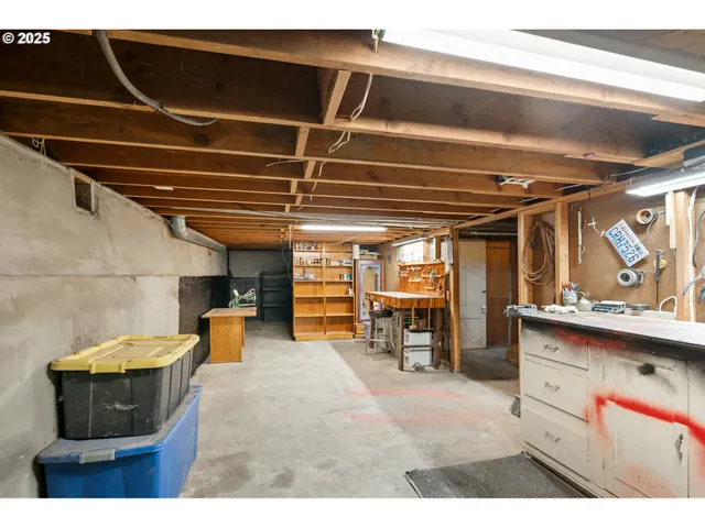 a utility room with sink dryer and chairs