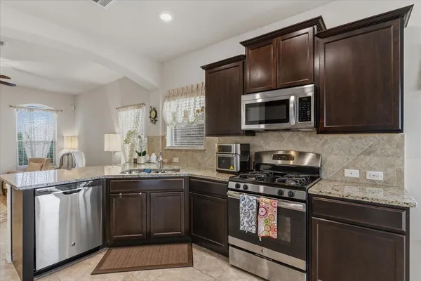 a kitchen with a sink stove and microwave