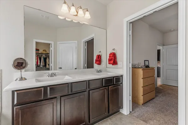 a bathroom with a sink vanity and mirror