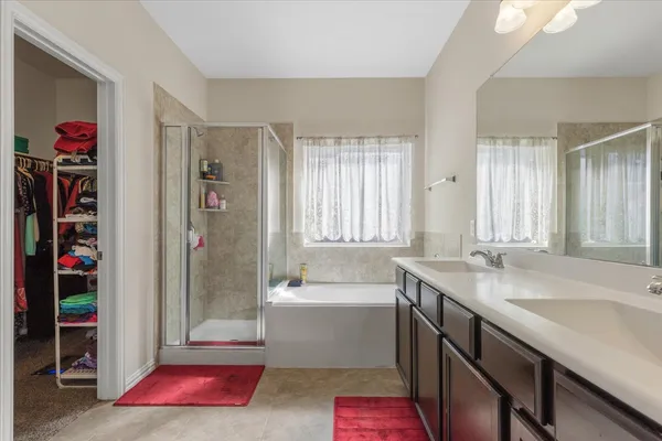 a bathroom with a tub sink and a mirror