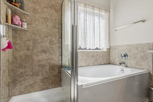 a bathroom with a bathtub and a shower