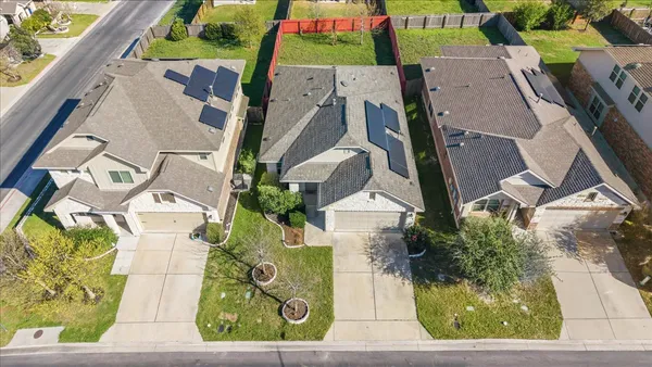 an aerial view of residential houses with outdoor space