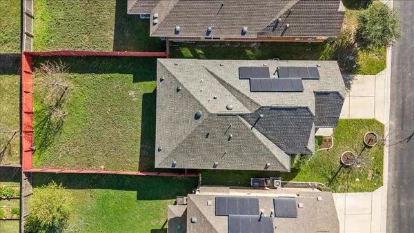 an aerial view of residential houses with outdoor space