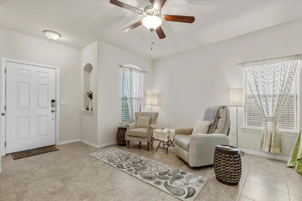 a living room with furniture and a chandelier