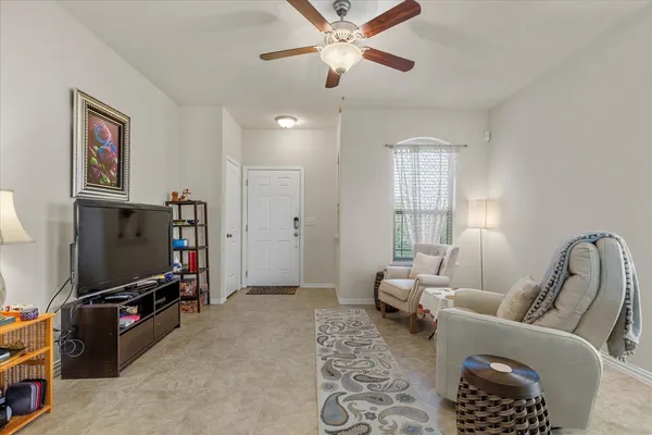 a living room with furniture and a flat screen tv