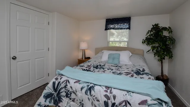 a bedroom with a bed and a potted plant