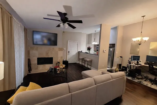a living room with furniture a fireplace and a flat screen tv