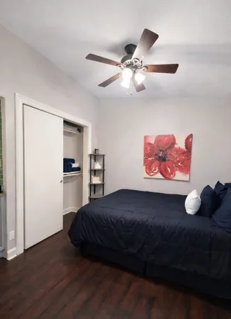 a bedroom with a bed and cabinets