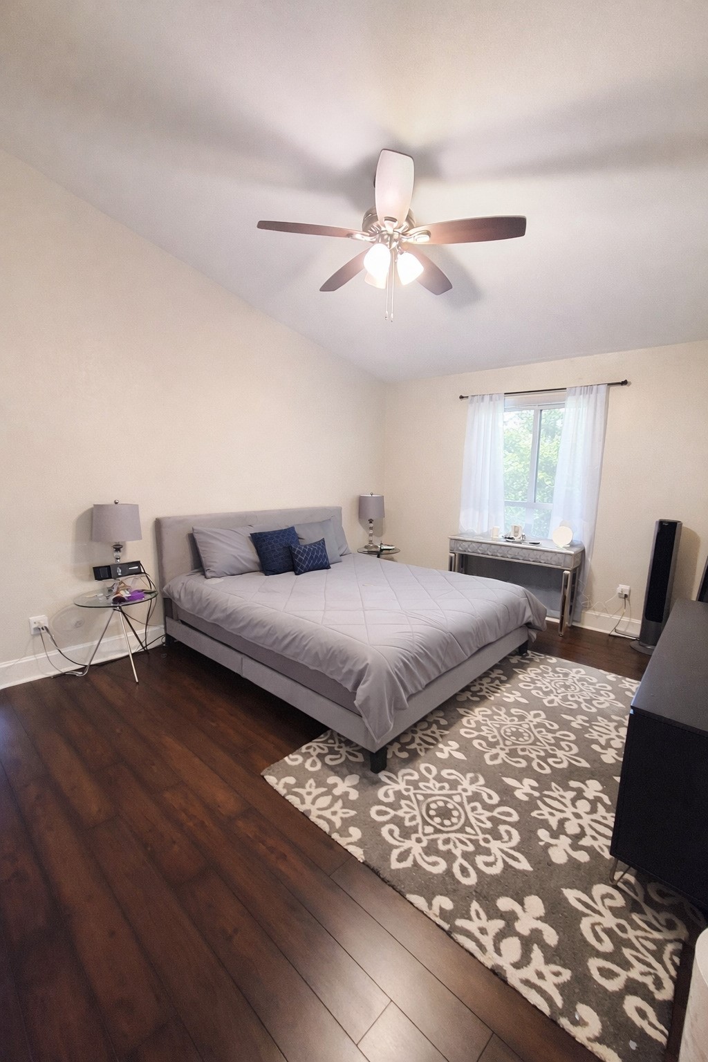 2425 Augusta Drive, Unit 4 Houston, TX 77057 - Photo 9 of 12 a bedroom with a large bed and wooden floor