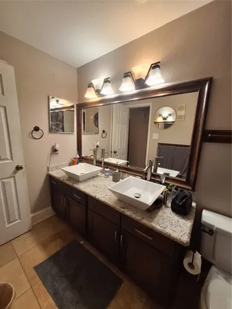 a bathroom with a double vanity sink and a mirror
