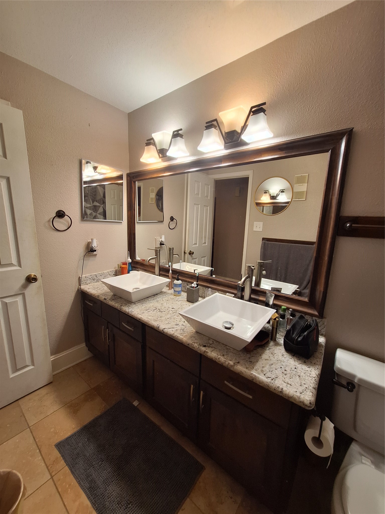 2425 Augusta Drive, Unit 4 Houston, TX 77057 - Photo 10 of 12 a bathroom with a double vanity sink and a mirror