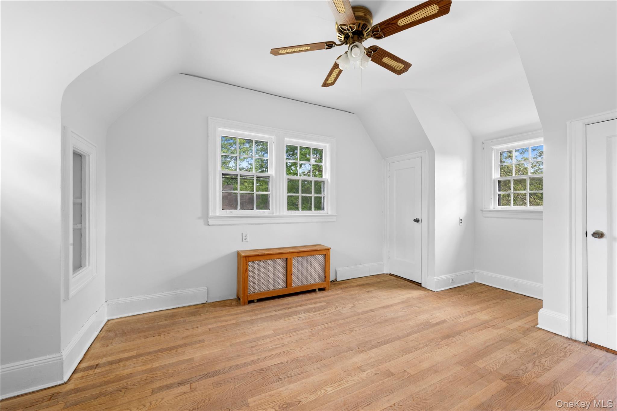 17 Old Orchard Road New Rochelle, NY 10804 - Photo 26 of 32 an empty room with wooden floor ceiling fan and windows