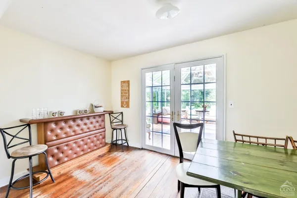 a view of a room with lots of furniture and wooden floor