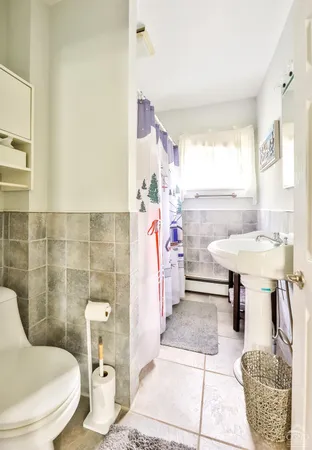 a bathroom with a sink toilet and a mirror