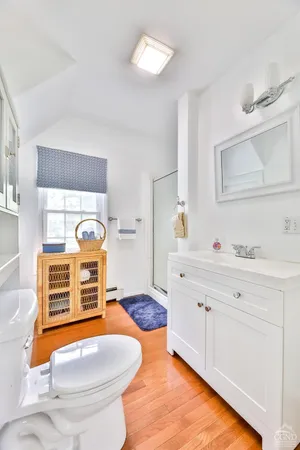 a bathroom with a sink toilet and mirror