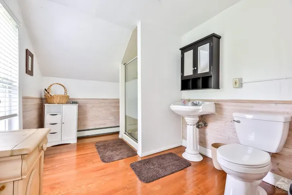 a bathroom with a sink toilet and mirror