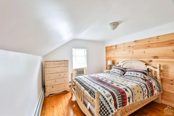 a bedroom with a bed and a dresser