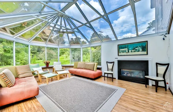 a living room with furniture ceiling fan and a rug
