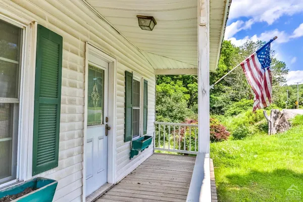 a view of a house with a yard and sitting area