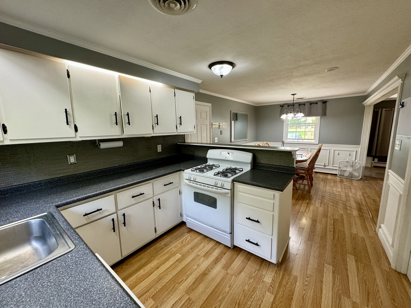 102 Cottage Avenue La Moille, IL 61330 - Photo 10 of 29 a kitchen with stainless steel appliances granite countertop a stove a sink and white cabinets