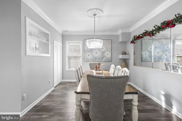a living room with furniture a chandelier and a mirror