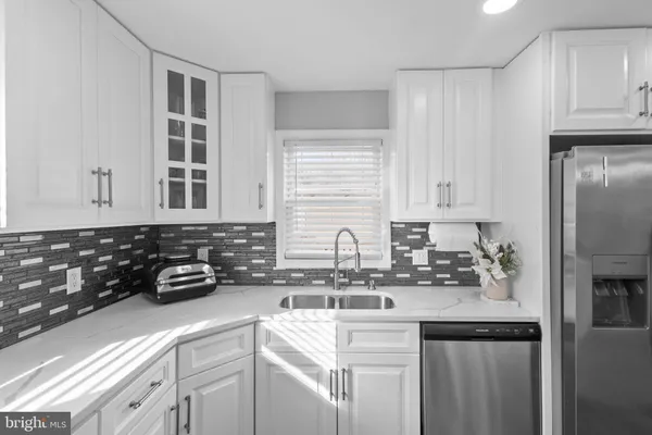 a bathroom with a granite countertop toilet a sink and a mirror