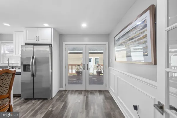 a view of a room with wooden floor and a bathroom