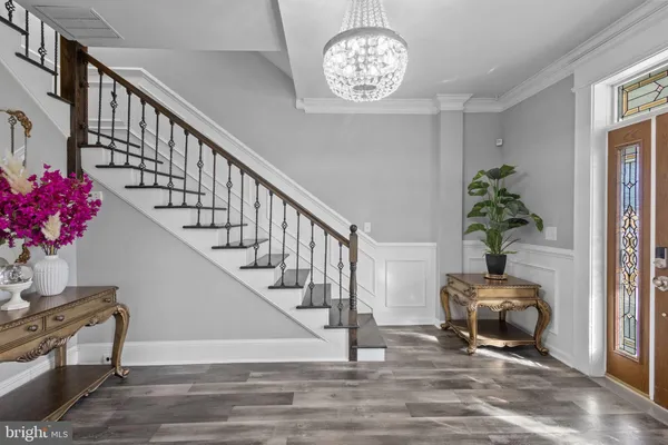 a view of a hallway with wooden floor and staircase