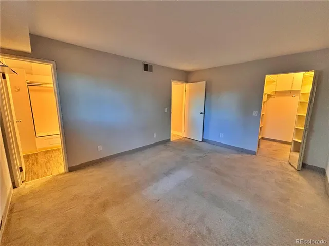 a view of walk in closet with wooden floor