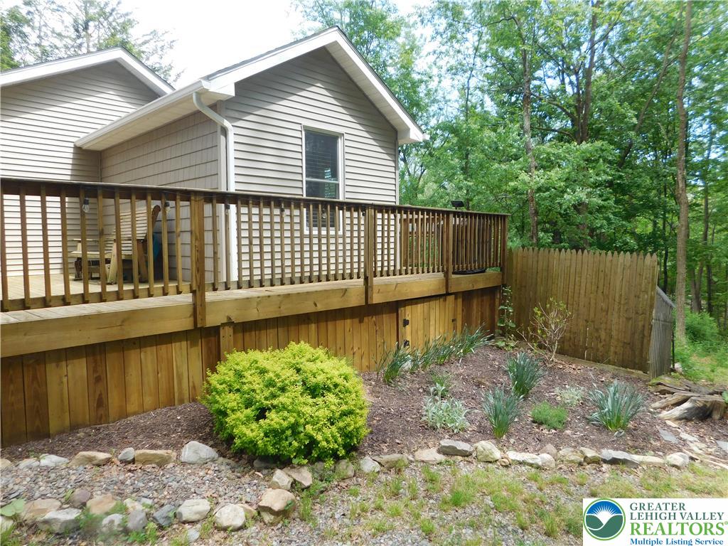 41 Reeder Street Mount Pocono, PA 18344 - Photo 6 of 41 A spacious elevated deck with wooden railings offers a tranquil outdoor retreat.