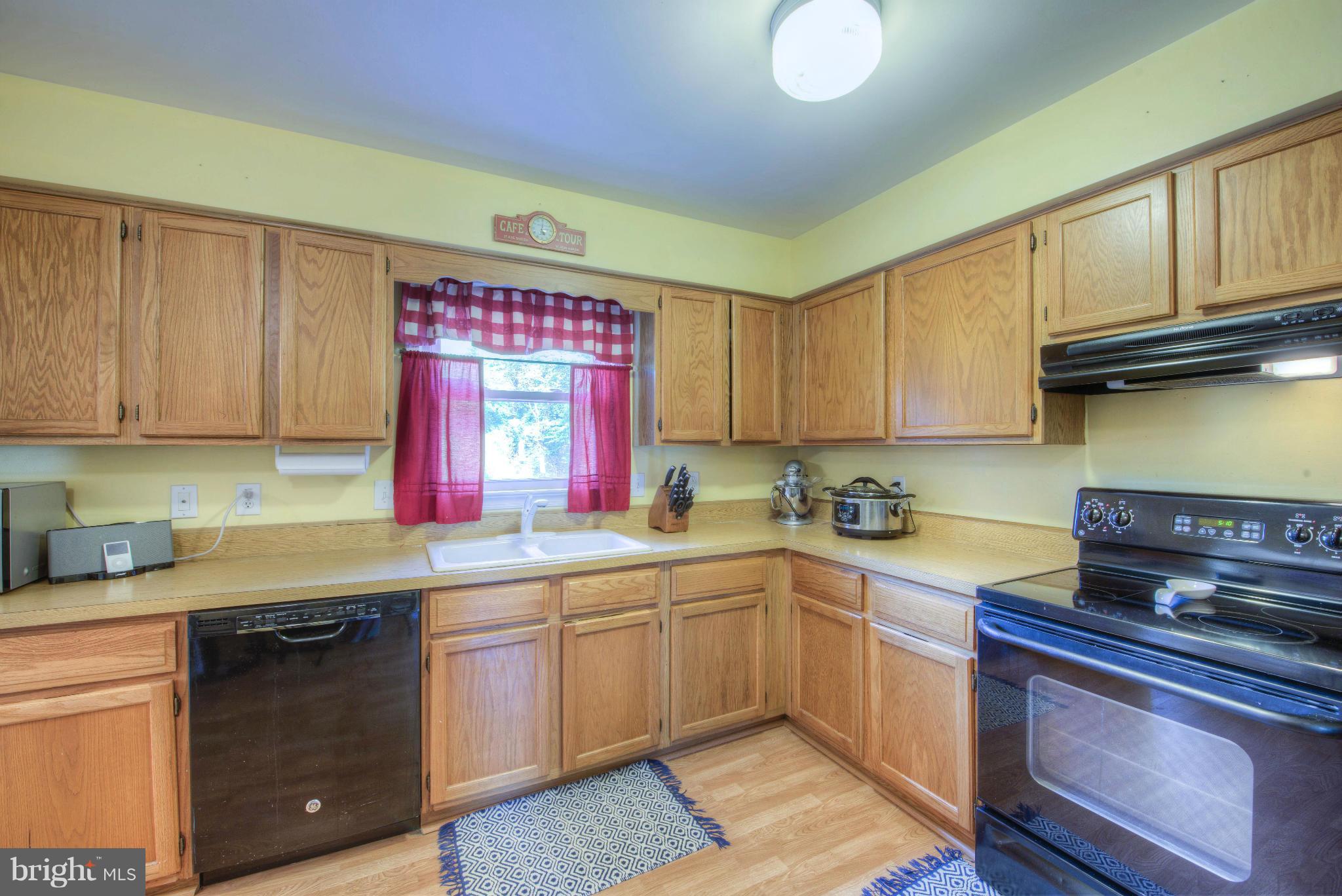 55 Buck Road Stafford, VA 22556 - Photo 5 of 19 a kitchen with stainless steel appliances granite countertop a sink dishwasher stove and cabinets with wooden floor
