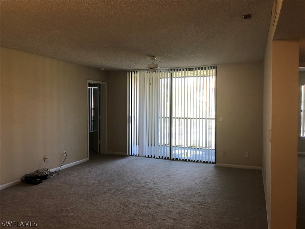 13561 Eagle Ridge Drive, Unit 1025 Fort Myers, FL 33912 - Photo 3 of 11 an empty room with windows