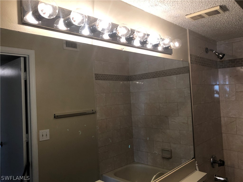 13561 Eagle Ridge Drive, Unit 1025 Fort Myers, FL 33912 - Photo 10 of 11 a bathroom with a shower
