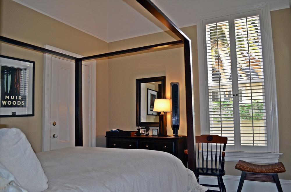 1219 Laguna Street Santa Barbara, CA 93101 - Photo 17 of 25 a bedroom with a bed and a chair