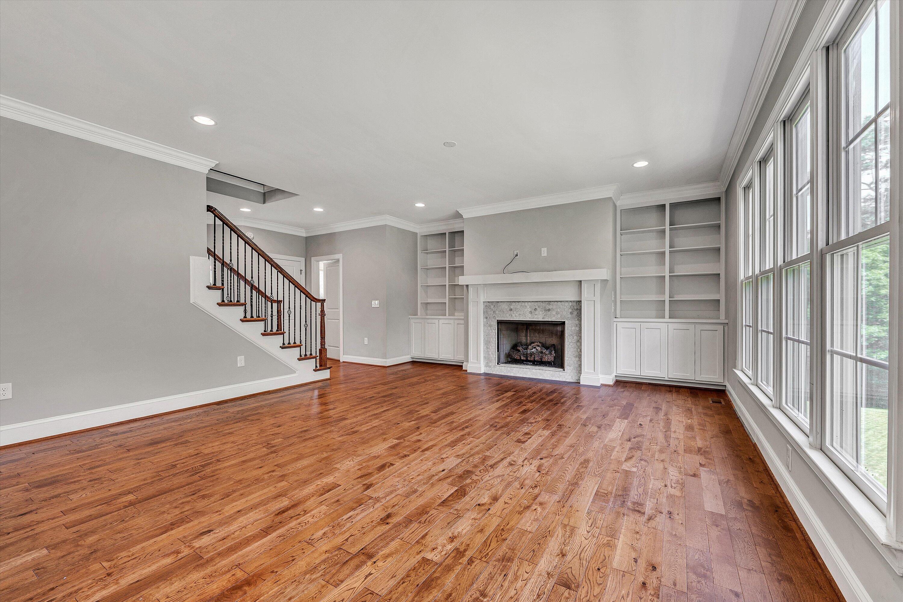 6981 Fairway Ridge Road Salem, VA 24153 - Photo 15 of 53 an empty room with wooden floor and fireplace