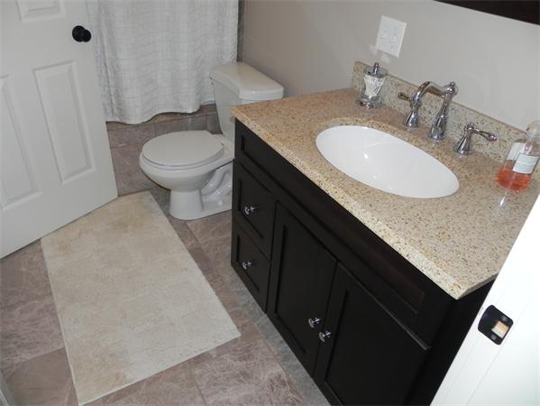 2 Birchmeadow Road Amesbury, MA 01913 - Photo 17 of 22 a bathroom with a granite countertop sink and a toilet