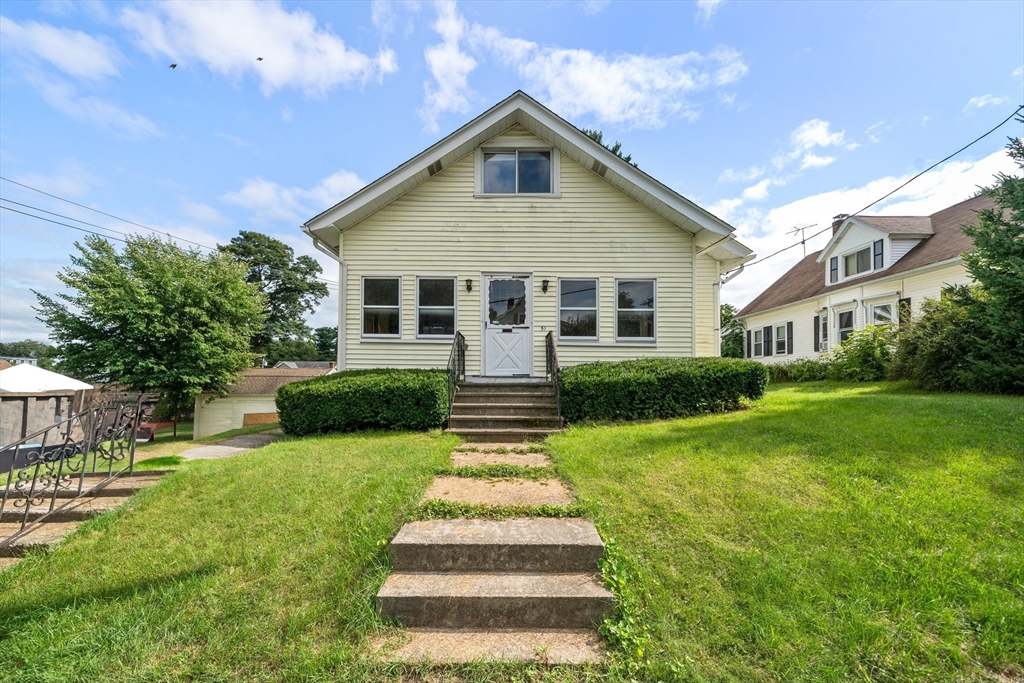 a front view of house with yard and green space