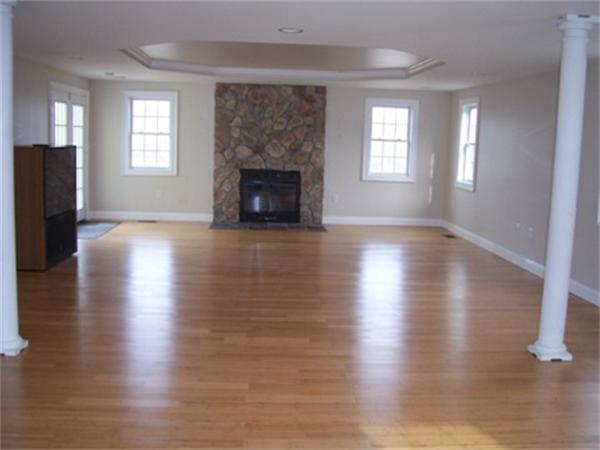 55 Perry Hill Road Acushnet, MA 02743 - Photo 8 of 13 an empty room with wooden floor fireplace and windows