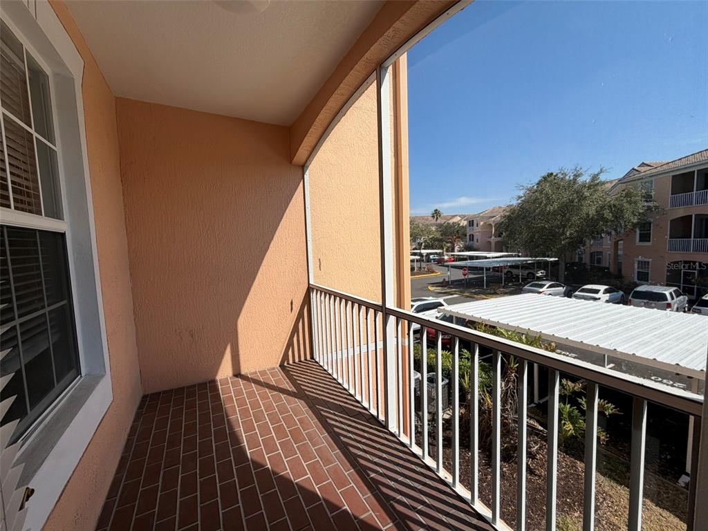 13524 Turtle Marsh Loop, Unit 621 Orlando, FL 32837 - Photo 14 of 14 a view of balcony with wooden floor and fence