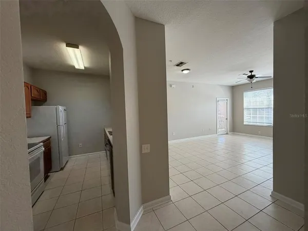a view of a kitchen with a refrigerator and cabinets