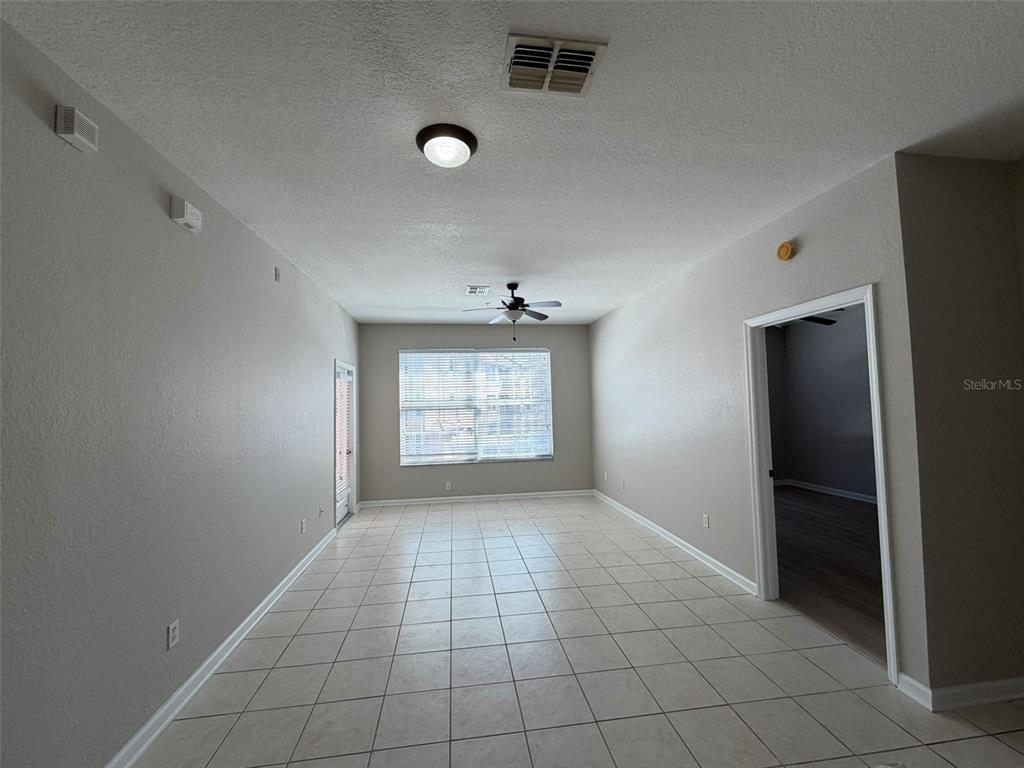 13524 Turtle Marsh Loop, Unit 621 Orlando, FL 32837 - Photo 6 of 14 an empty room with windows and closet