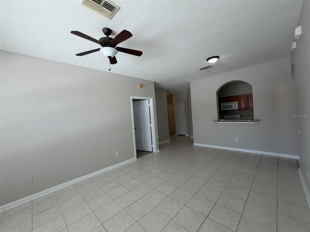 13524 Turtle Marsh Loop, Unit 621 Orlando, FL 32837 - Photo 8 of 14 a view of a livingroom with a ceiling fan and window
