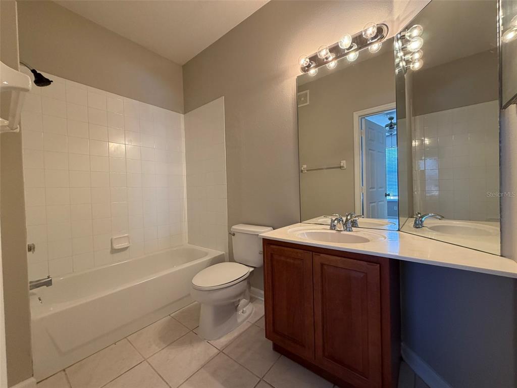 13524 Turtle Marsh Loop, Unit 621 Orlando, FL 32837 - Photo 10 of 14 a bathroom with a sink a toilet and shower
